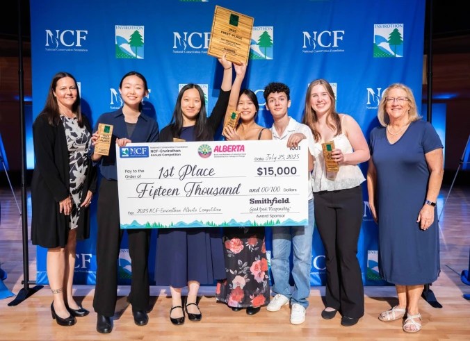 A group of 2025 Massachusetts Envirothon Champions from Lexington High School holding a $15,000 check