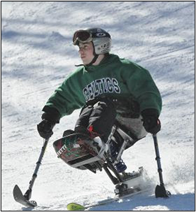 Young adult is skiing downhill on a sit ski with adaptive poles. 