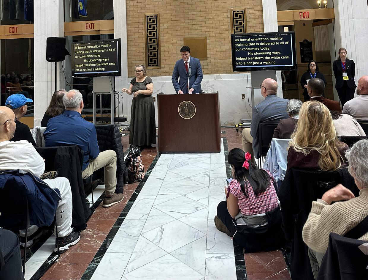 John Oliveira speaking to the crowd at the podium 