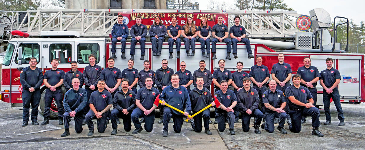 firefighters on and around a ladder truck