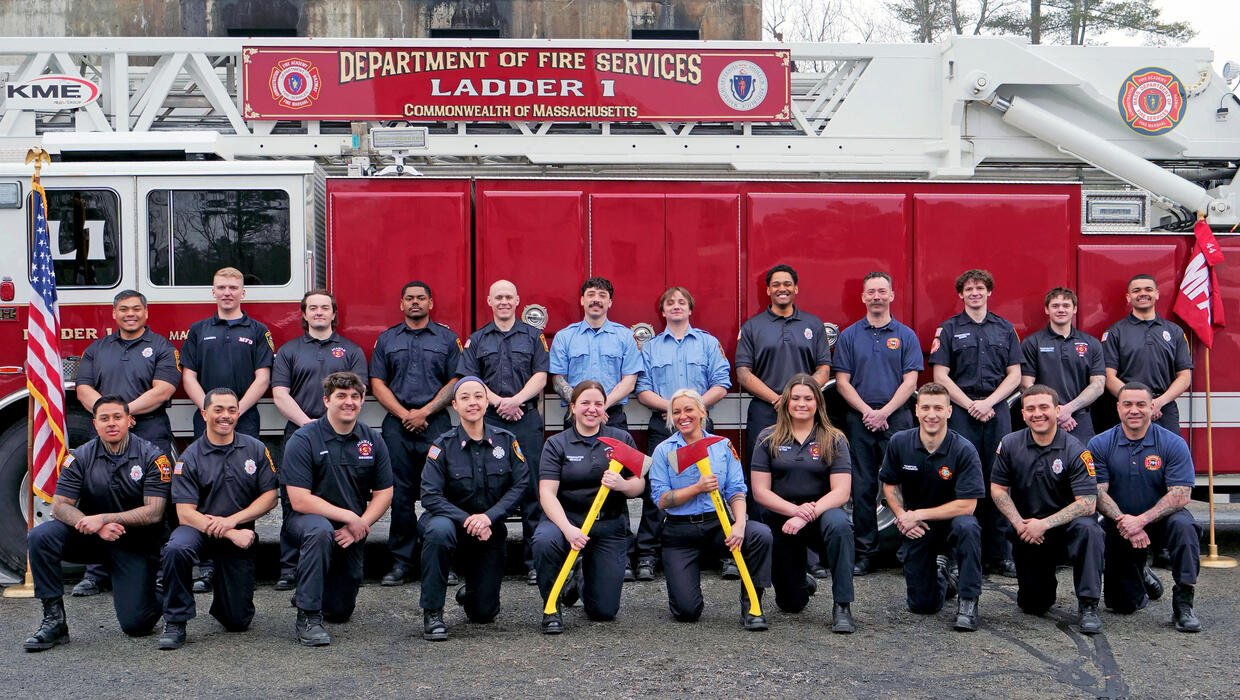 firefighters on and around a ladder truck