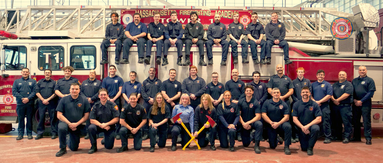 firefighters on and around a ladder truck