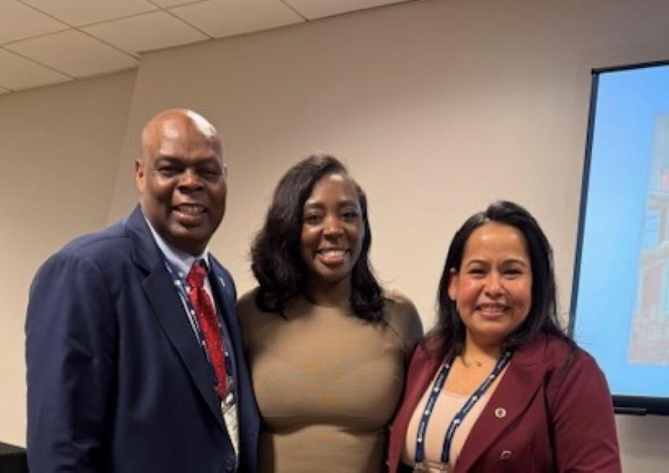 Three people pose together