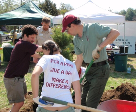 A group of volunteers working with a shovel.