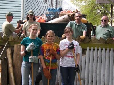 Volunteers and staff posing in front of a dumpster at a 2007 Park Serve Day event.