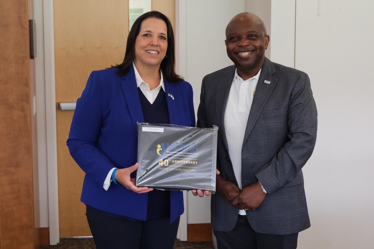 Lieutenant Governor Driscoll smiles beside MCDHH Commissioner Sotonwa in Holyoke, MA.
