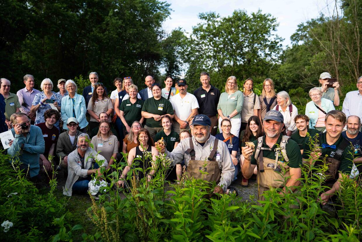 group of people gathered to celebrate turtle release
