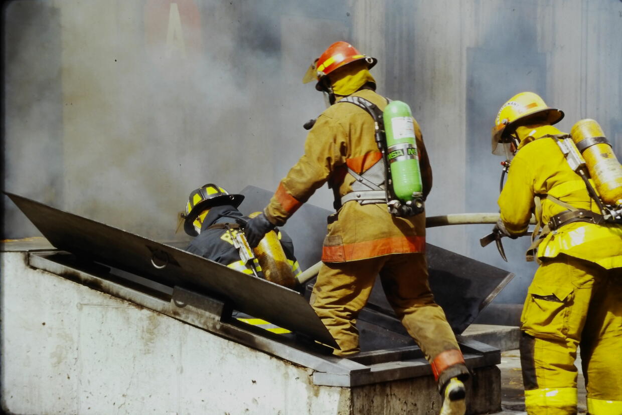 Firefighters enter the bulkhead of the Massachusetts Firefighting Academy's first burn building