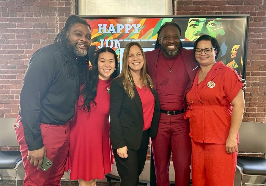Five people dressed in red and black.