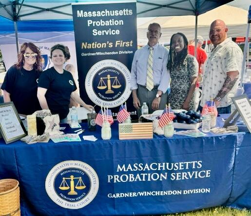 Five people from MPS staffing an outdoor event under a tent.