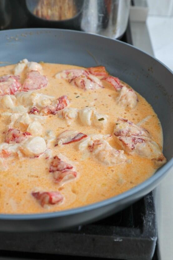 Orange sauce with lobster chunks. 