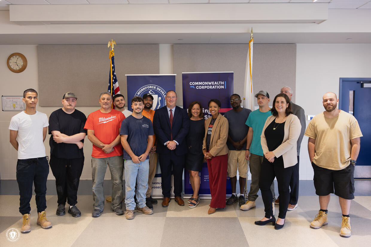 Secretary Jones takes a photo with Career Technical Initiative students at Greater New Bedford Technical School
