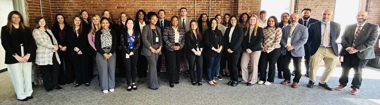 A large group of probation officers in business attire. 
