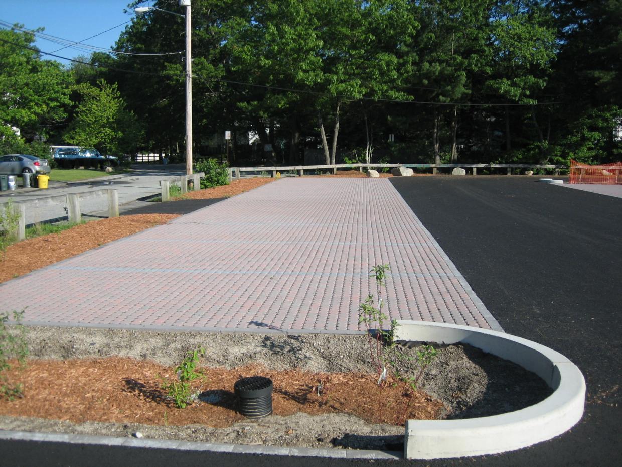 Permeable pavers, porous asphalt, and bioretention cells at the Silver Lake beach parking lot, Wilmington MA (photo: GeoSyntec Consultants)