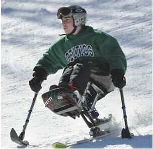 A skier skis down a hill on a mono ski. The skier has two short poles with ski blades on the end of them, which he is pressing against the snow to steer.