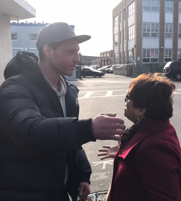 South Boston Assistant Chief Probation Officer Marynel Sanchez hands out Christmas bags outside the homeless shelter.