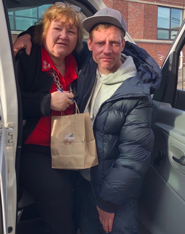South Boston Probation Officer Barbara Loftus hands out Christmas bags. 
