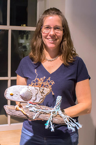 Jessica Lister, of Monson, with her debris artwork.