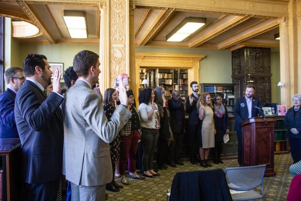 Senator Julian Cyr leads the Commission members in their formal swearing-in ceremony. 