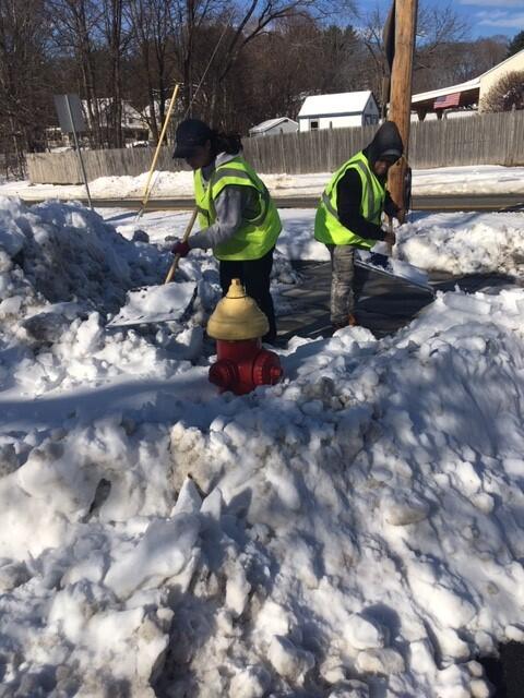 Probationers help the fire department shovel out fire hydrants.