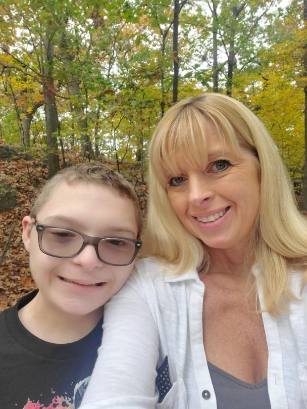 Melissa Remington and one of her children enjoy the outdoor scenery of the fall season together.