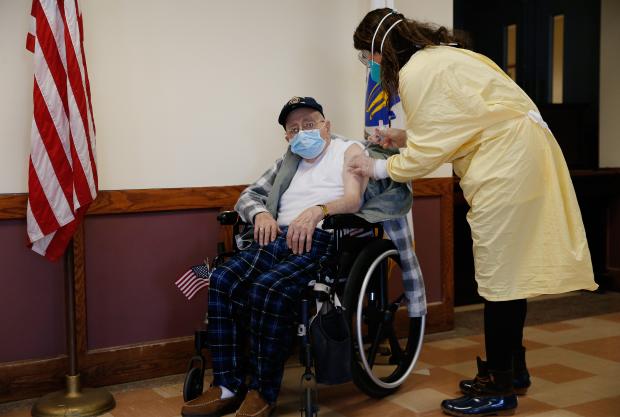 Dominic Pitella, 94, a U.S. Army Air Corps veteran and resident at the Soldiers’ Home in Chelsea, receiving the first COVID-19 vaccine at the Home. Photo credit: Jessica Rinaldi/The Boston Globe