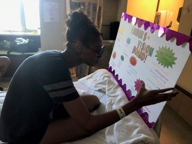 Amber Ward working in a hospital room on her Vision Board