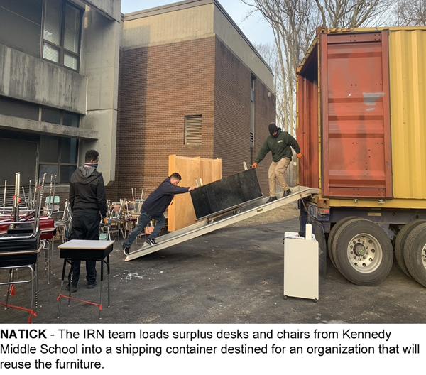 Image of surplus school furniture being loaded into shipping container.