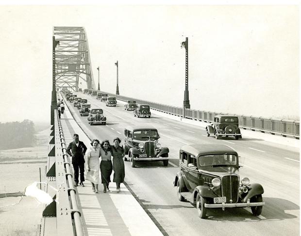 Historic photo of people walking on bridge
