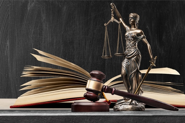 Symbolic image of indictment with gavel and blind Justice