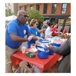 man serving refreshments at table