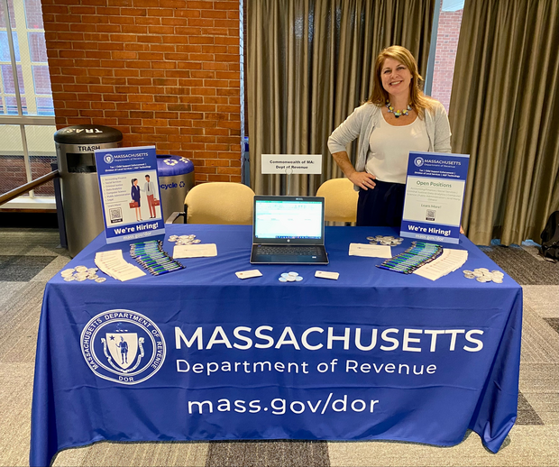 DOR employee standing at a job fair table