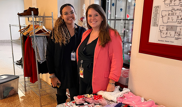 Probation Officers Taylor Depina-Centeio and Sarah Fortin with clothing donations.