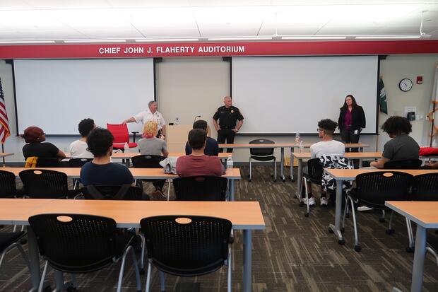 Fire chiefs and officials speaking to high school students in an auditorium