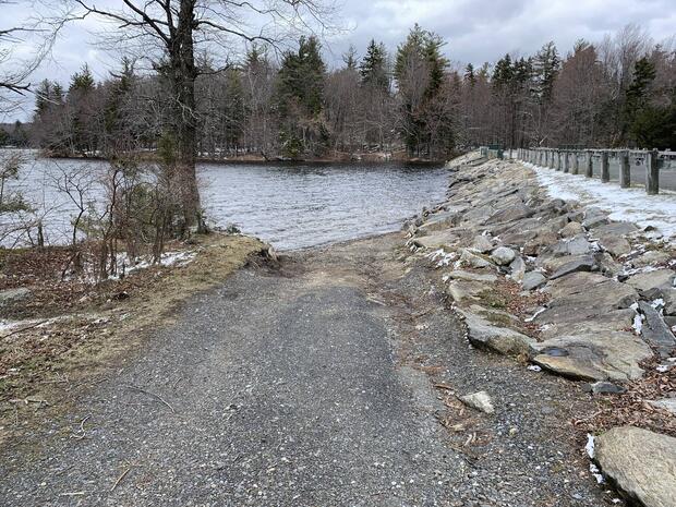 eroded gravel launch parallel to main road leading to waters edge
