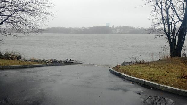 curved approach of paved boat ramp terminating at waters edge