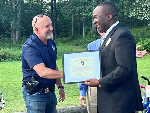 Randolph Police Chief Anthony Marag (left) presents Paul Nwokeji (right) with the Award of Appreciation.