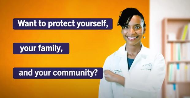 Screenshot of a YouTube video that shows a female doctor pointing at text about protecting oneself and their community by staying up to date on COVID and flu vaccines