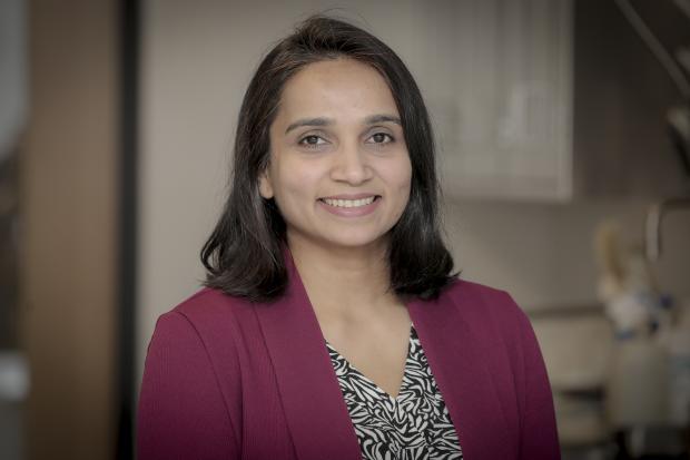 Pinal Patel works at Massachusetts State Public Health Laboratory. It is a headshot of Pinal. Pinal has long dark hair and she is smiling at the camera.