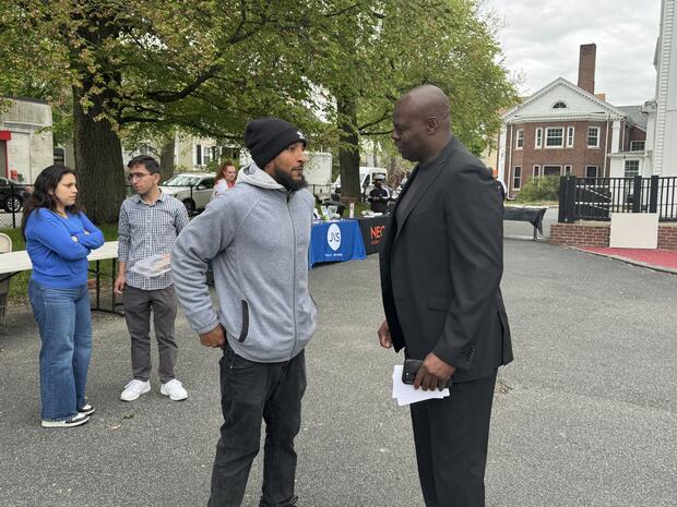 Commissioner Pamerson Ifill speaks with Reentry Fair attendee Perry.