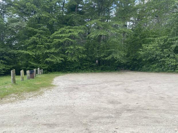 Small sandy parking area near the launch