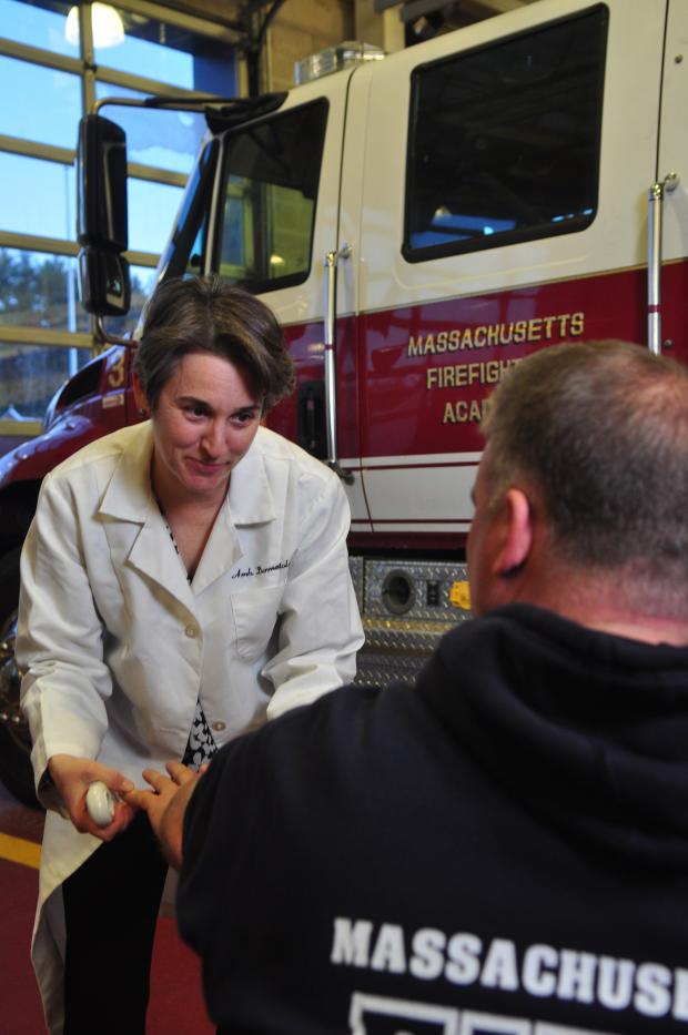 Dr. Kannler performs a free skin cancer screening in a fire station. 