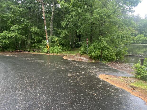paved boat ramp abutting road leading to water