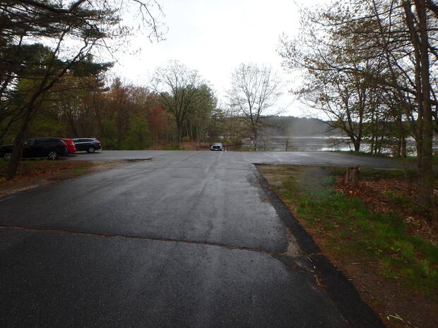 large paved parking lot with ramp at end