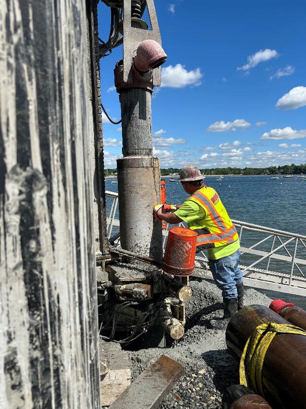 A construction worker installing steel piling for the new Salem Willows fishing pier.