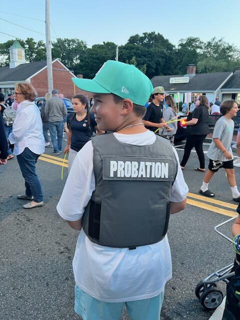 A child wearing a probation vest. 
