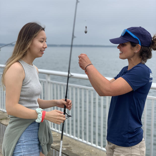 A new angler learning how to saltwater fish during the Fort Taber fishing clinic.