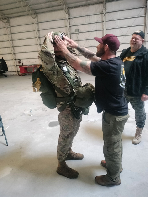 parachuter gearing up before going into a plane