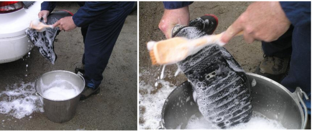 Person scrubbing boots before entering animal area 
