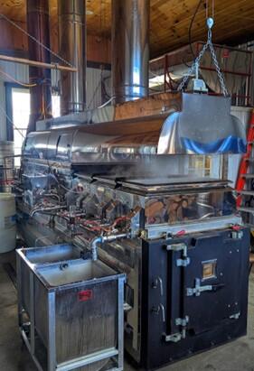 Maple syrup evaporator in a farm building